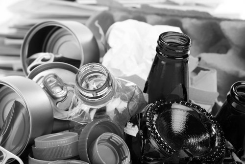 Worker placing a skip beside a driveway